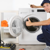 An expert providing Appliance Maintenance Tips by repairing a washing machine.